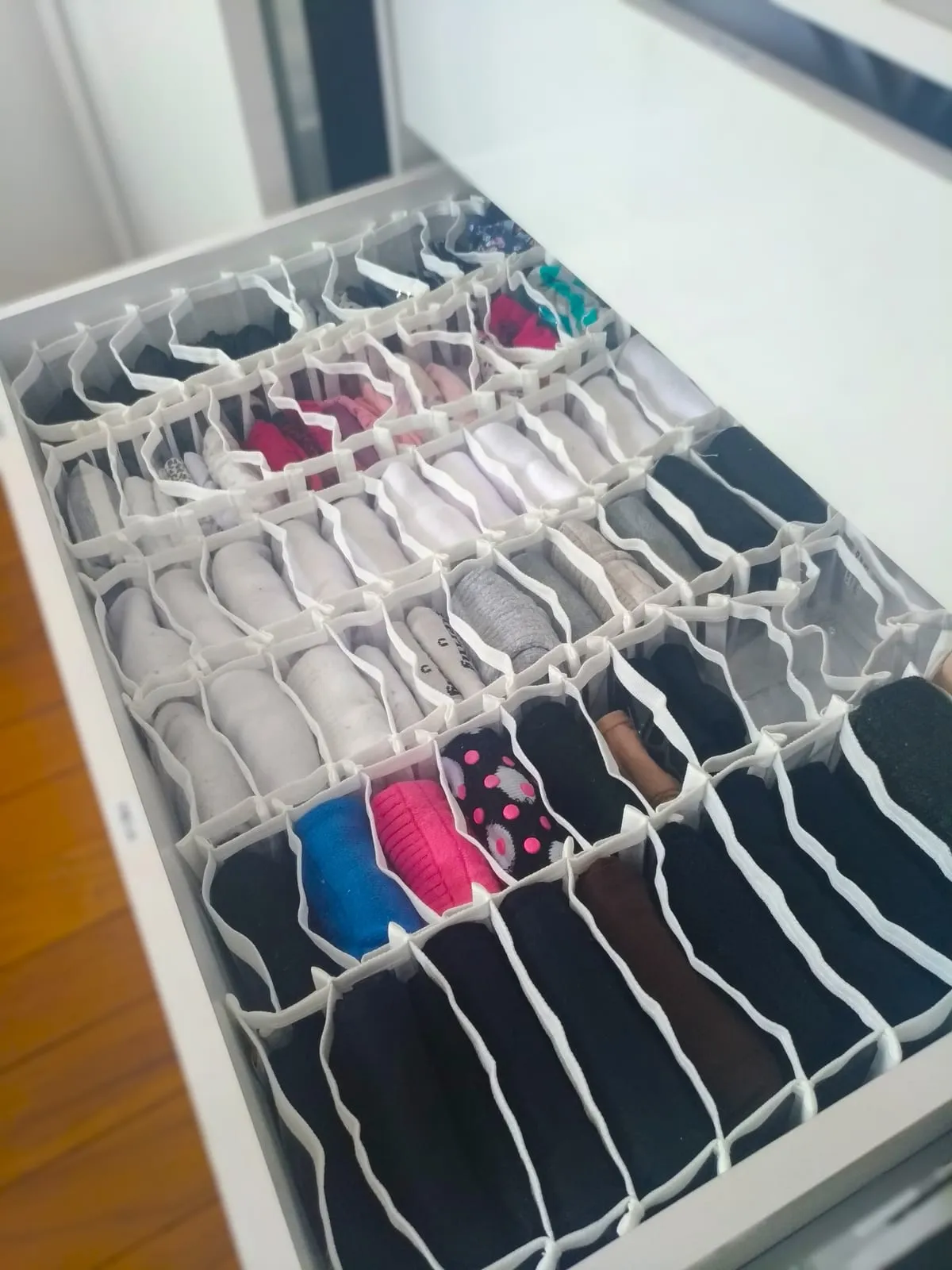 Cajón con organizador de celdas donde cada prenda de ropa interior ocupa su propio compartimento.